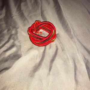 Red and gold beaded bracelet made in Nigeria.